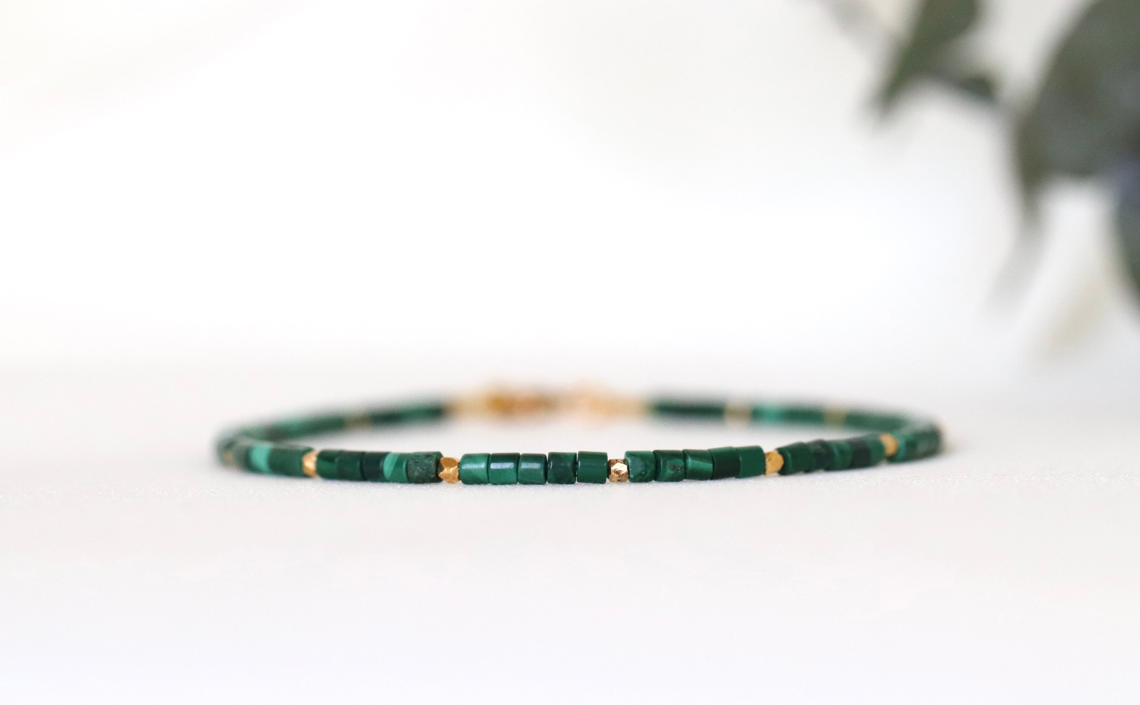 Green beaded bracelet on a white background